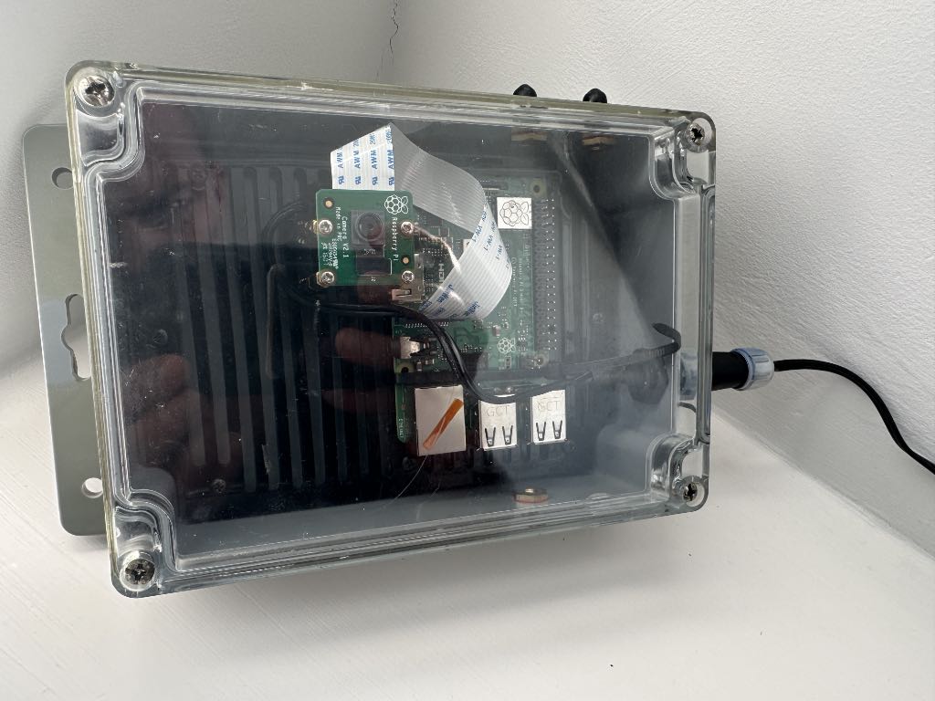 a raspberry pi and a camera in a weatherproof box